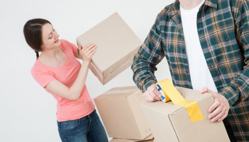 Moving van and packed boxes for a home move in Putney