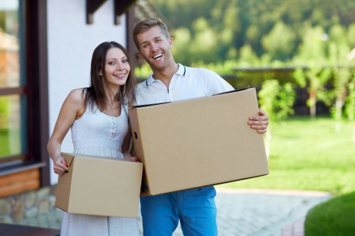 Unpacking boxes into rooms after a move in Putney