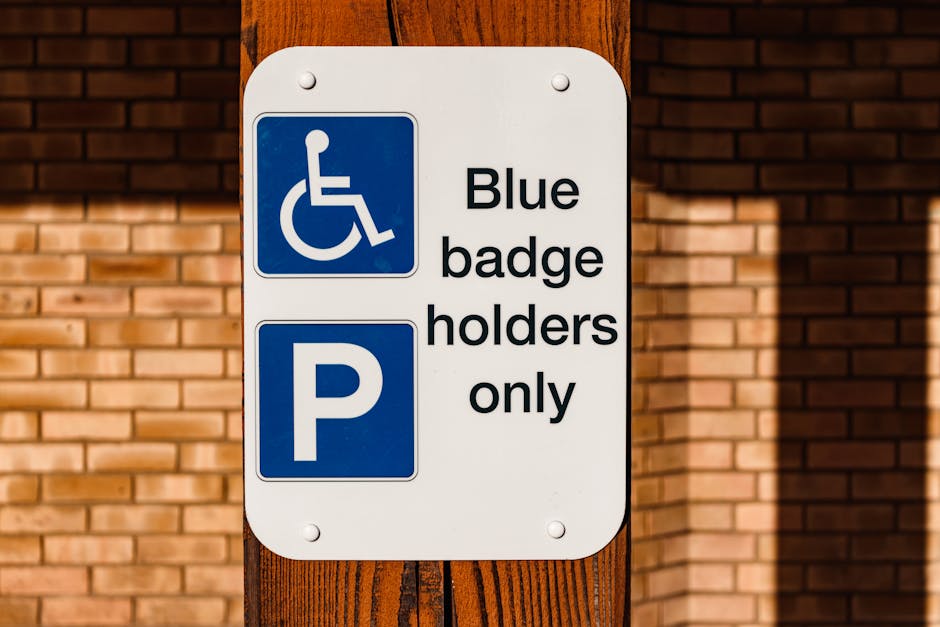 Four blue parking signs with the letter 'P' and the text 'vergunninghouders' and 'AUTODATE' are mounted on thin black poles in front of a metallic corrugated wall. The signs are positioned along the pavement, with the largest sign placed directly in front of the wall, and the others slightly tilted, indicating designated parking areas for permit holders near a property. The wall's surface features vertical ridges that reflect ambient light, creating a subtle shine. The area appears well-lit, with soft shadows cast by the signs. This image relates to house removals and moving services, highlighting the importance of understanding local parking regulations on move day, which Putney Man and Van can assist with during furniture transport and home relocation processes.